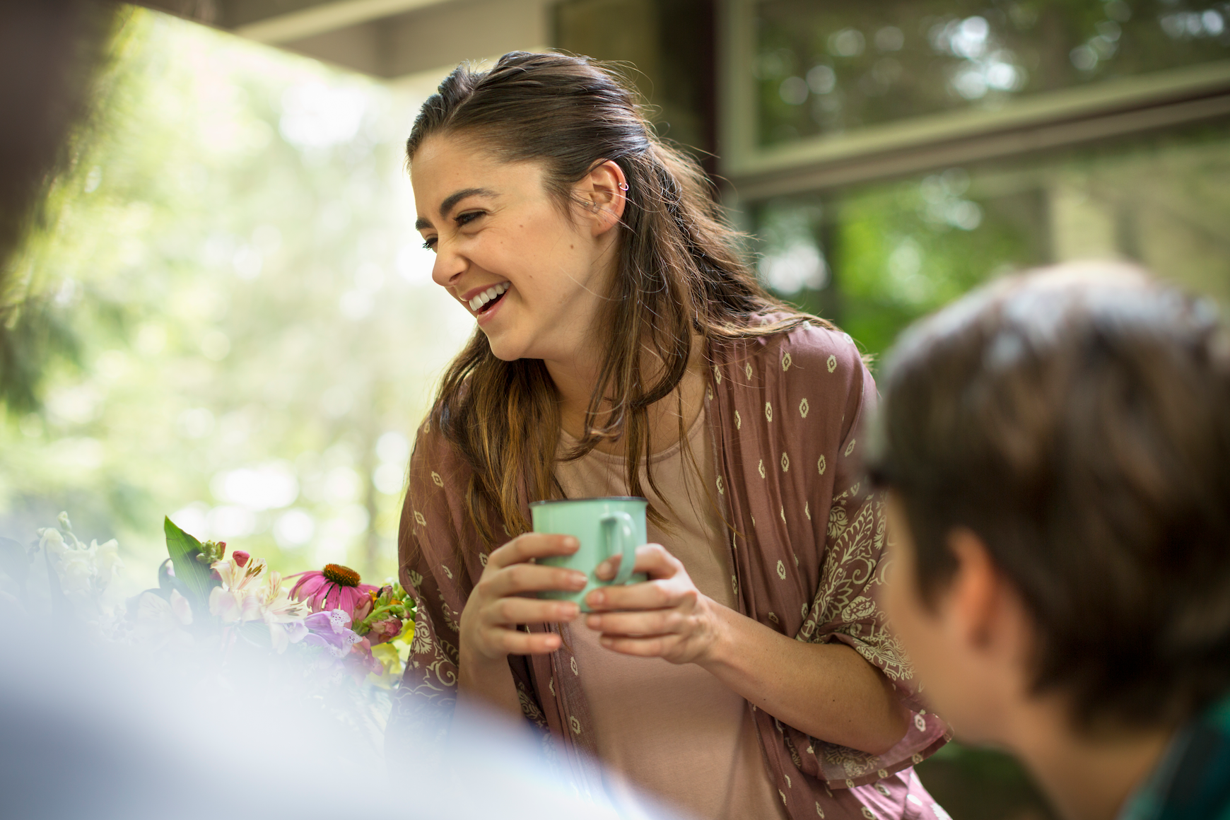 Happy woman holding a mug.